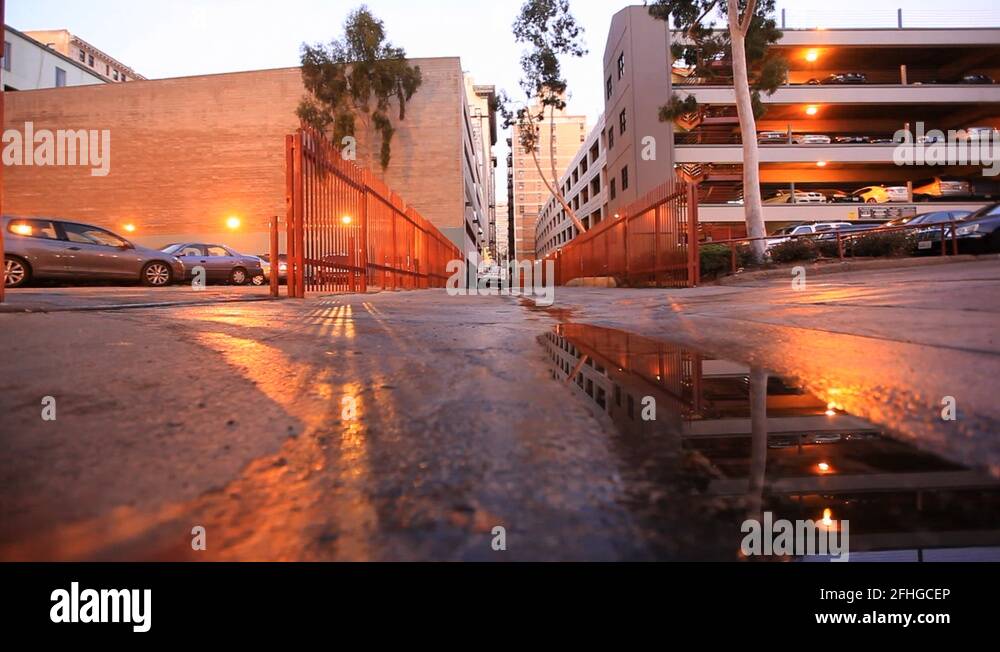 Man Walking Over Puddle and Car Pulling Up Stock Video Footage Alamy
