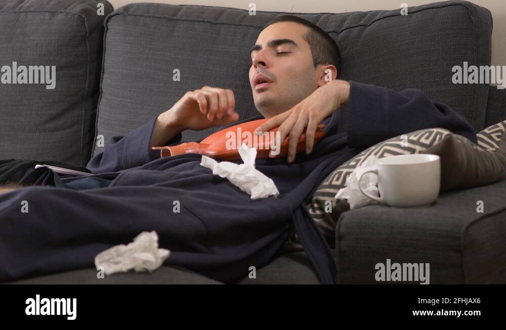 Sick Man Coughing and Feeling Chest Pain at Home in a Bathrobe Stock