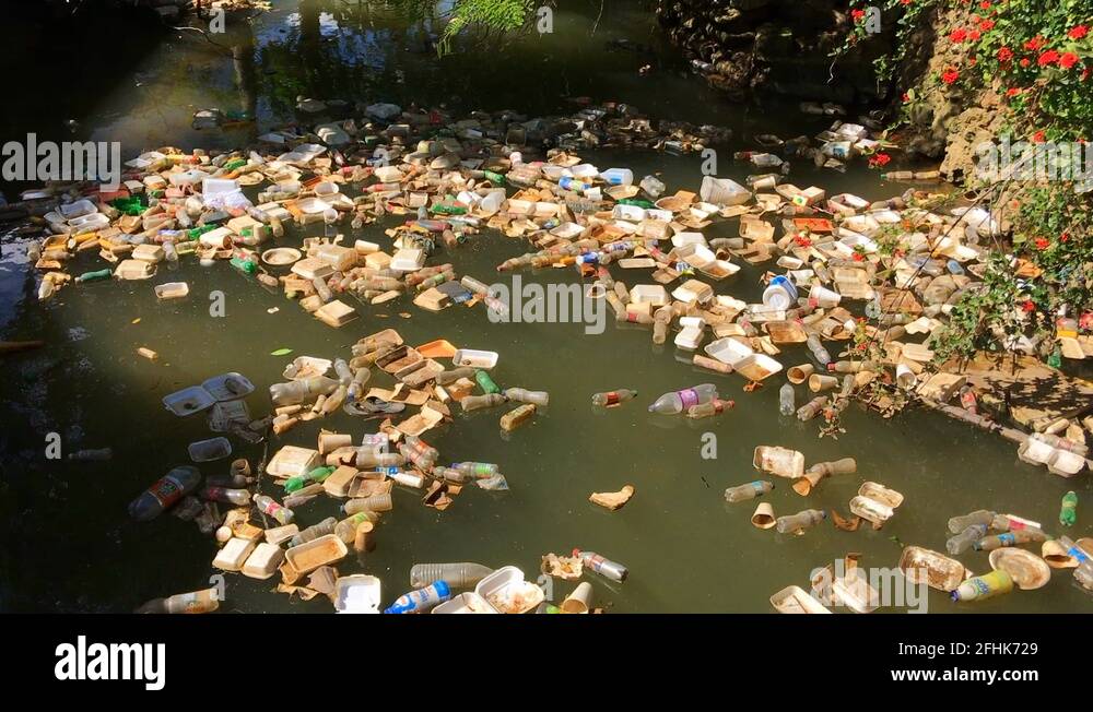 Floating garbage in a canal by the sea in Dominican Republic Stock
