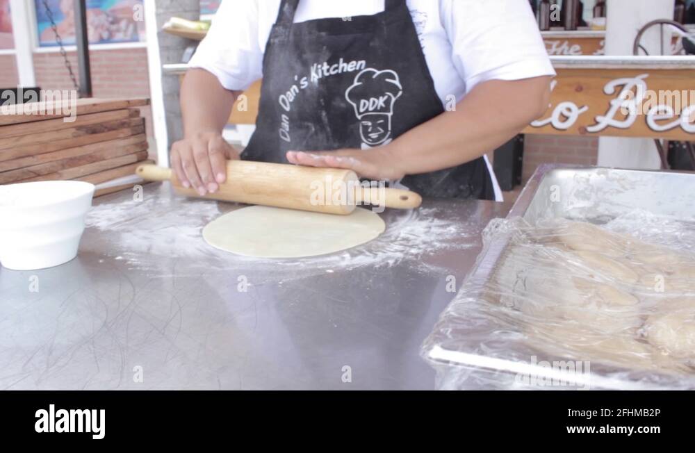 rolling out dough for flour mexican flour tortillas and placing on