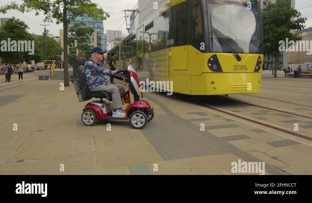 Man on mobility scooter at train station Stock Videos & Footage HD