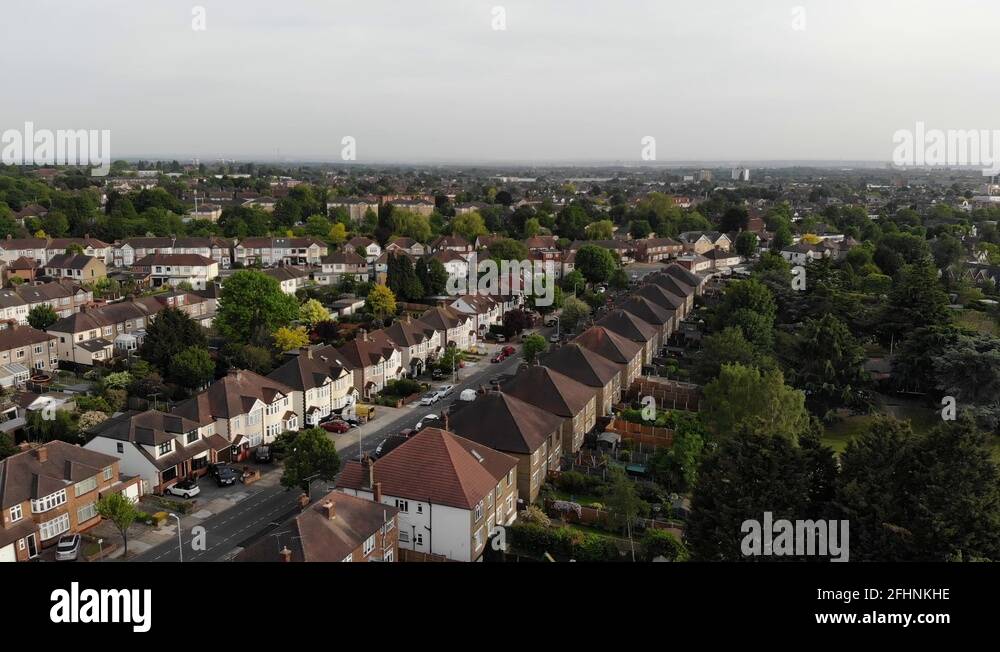 Aerial footage of identical houses lined up near lodge farm park in