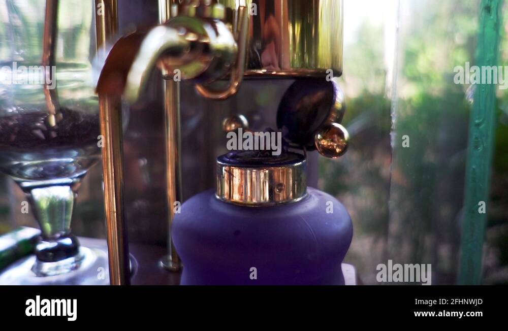 slow motion old fashioned coffee machine brewing Tegal Sari Kopi Luwak Coffee Stock Video