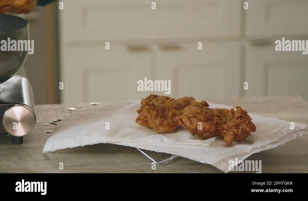 Placing Fried Chicken on Cooling Rack with Paper Towels Stock Video