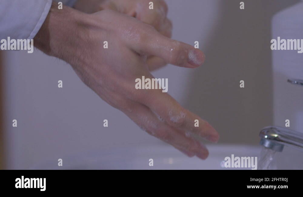 Disinfection of hands before surgery. The doctor carefully washes his