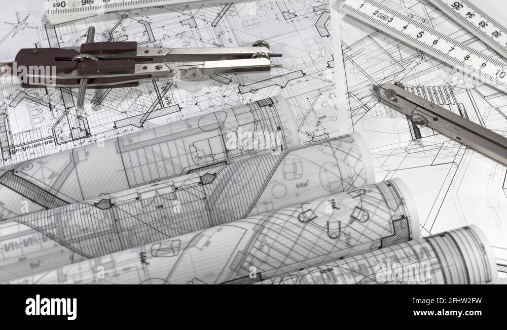 Blueprints rolls of architectural drawings, folding ruler and compass