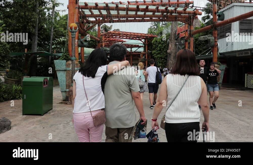 SLOW MOTION Family walking around in Universal Studios Singapore
