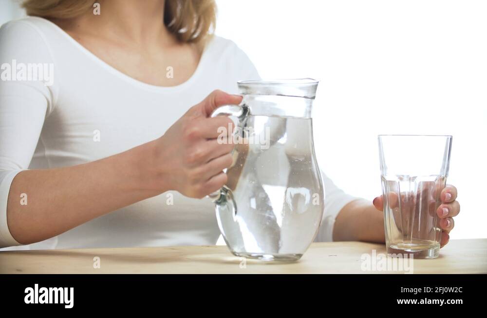 Woman Pouring Water Into Glass From Jug Closeup Stock Video Footage Alamy