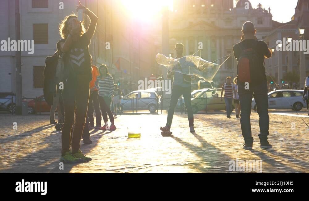 LENS FLARE: Tourists in Rome watching street artist make large soap ...
