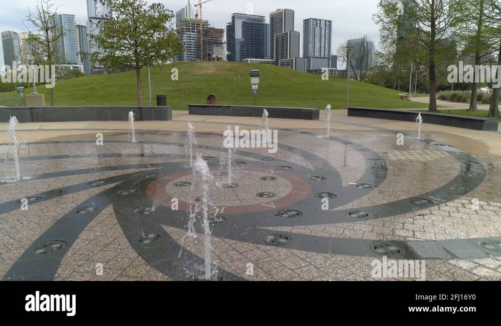 Slow motion at eye level orbiting the fountains located at the Liz