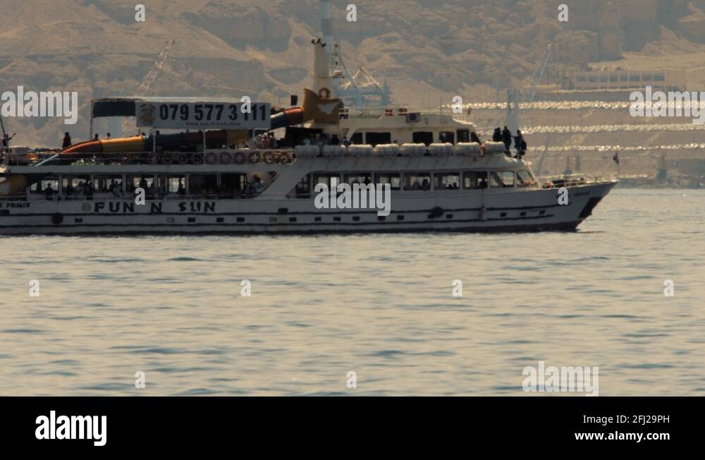 The Gulf of Aqaba, Jordan. Tour boat cross the frame from left. 4K
