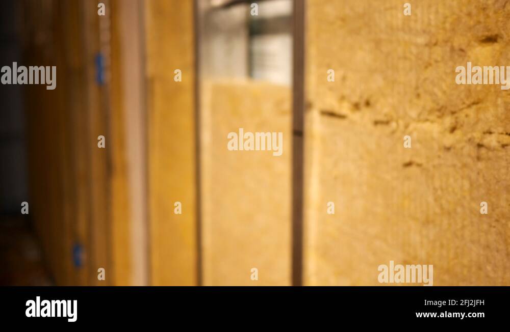 Camera pans across unfinished basement to uncovered electrical box