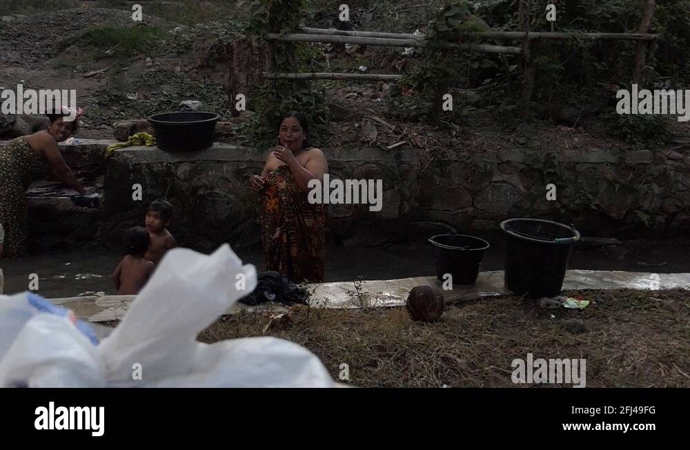Indonesian people taking bath in river after earthquake Stock Video