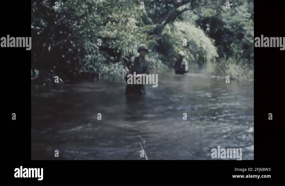 Korean soldiers move through the jungle and cross a swamp 1969 Stock