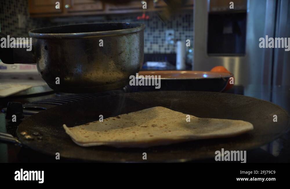 Cooking roti on the stove top Stock Video Footage Alamy