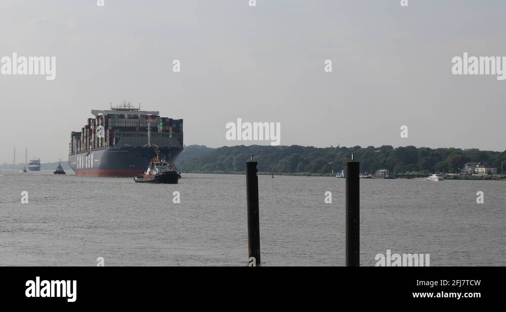 Huge container ship CMA CGM Benjamin Franklin entering Hamburg harbour ...