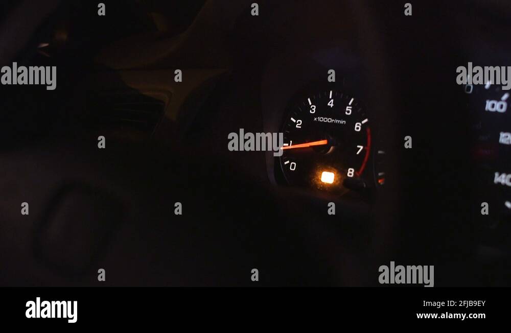 RPM Gauge car engine reving low RPMs through steering wheel Stock Video Footage Alamy