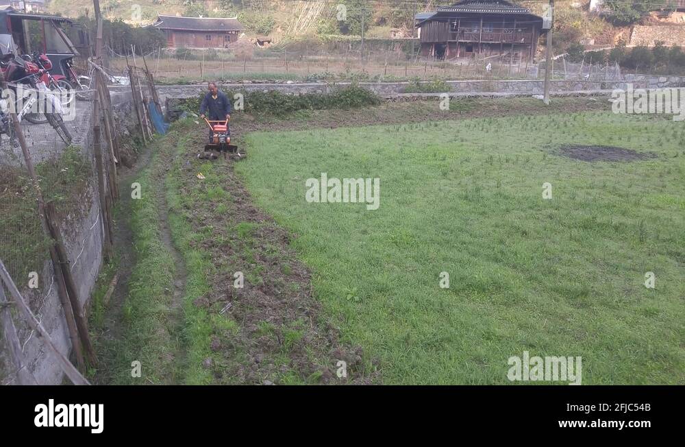 The farmers are ploughing by machine Stock Video Footage - Alamy