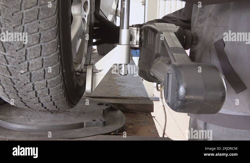 Car wheel fixed with computerized wheel alignment machine Stock Video