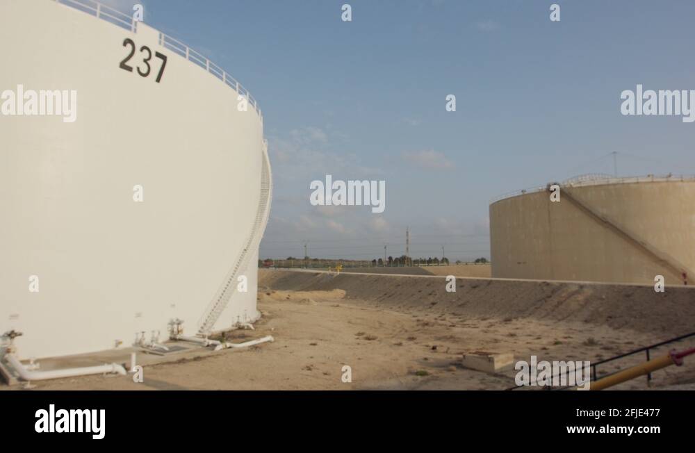 Large crude oil storage tanks in a huge refinery Stock Video Footage