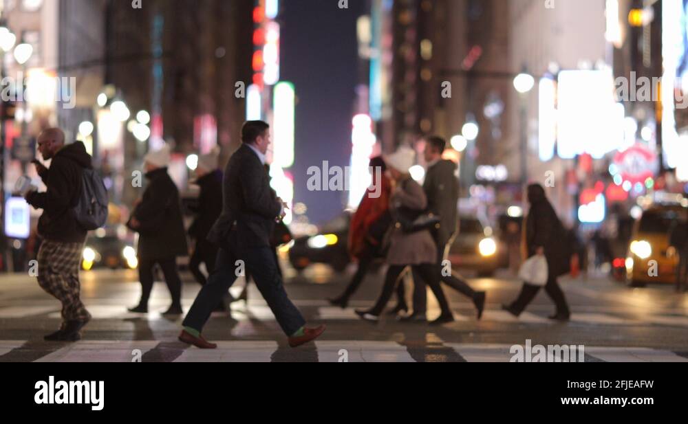 Crowd of people walking street slow motion New York City at night Stock ...