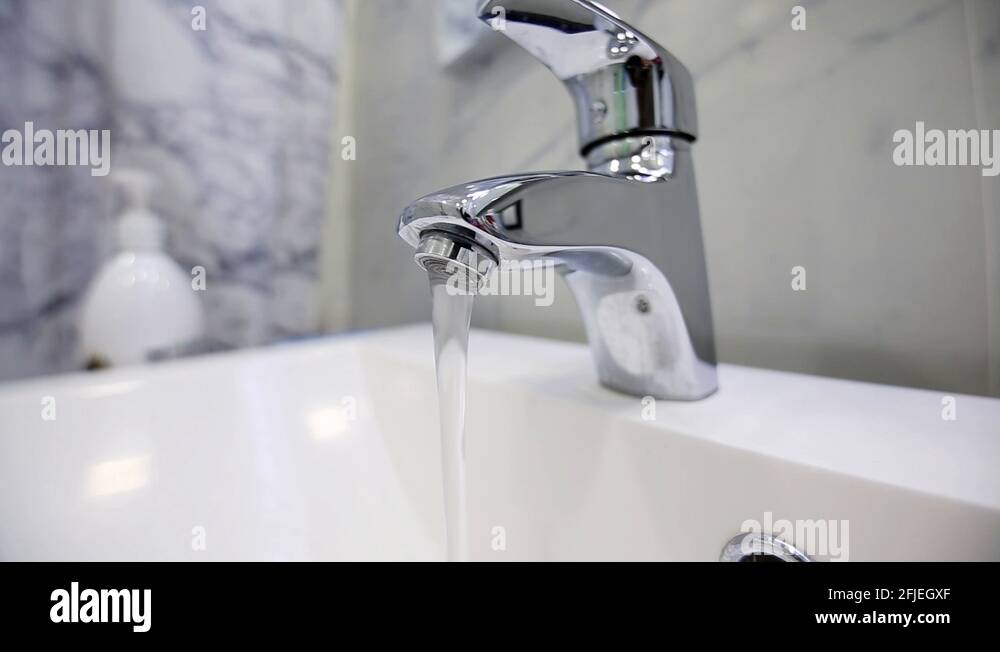 flowing from the modern tap water in the bathroom. saving of natural