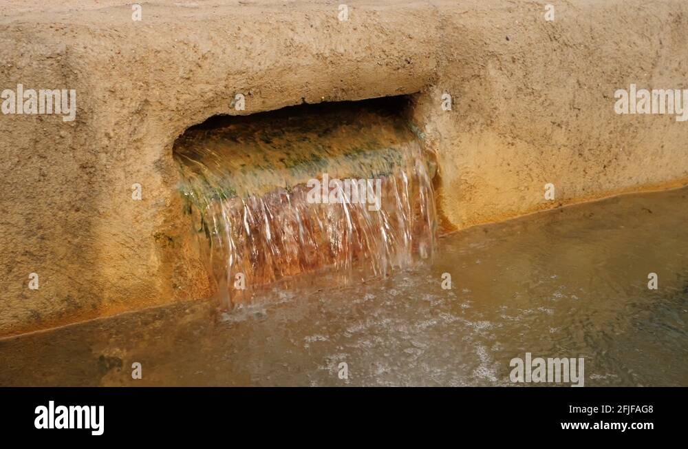 Water Pouring Out From Hole At The Side Of A Natural Salt Water Hot