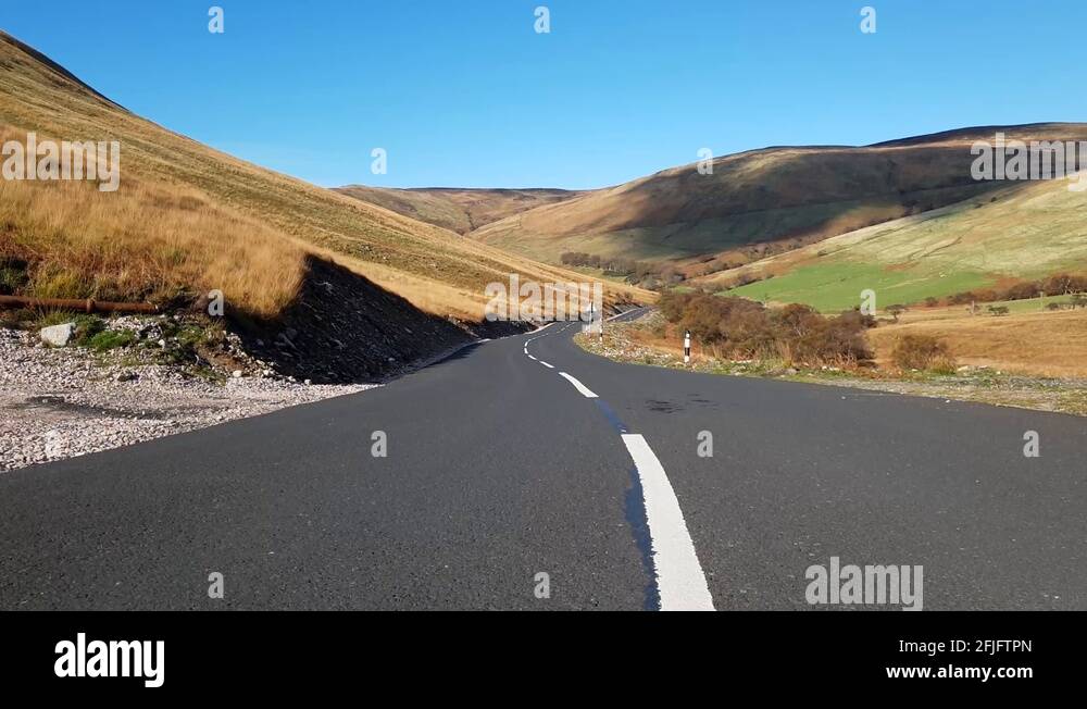 jib/crane shot whilsting forward from the centre of a road and lifting
