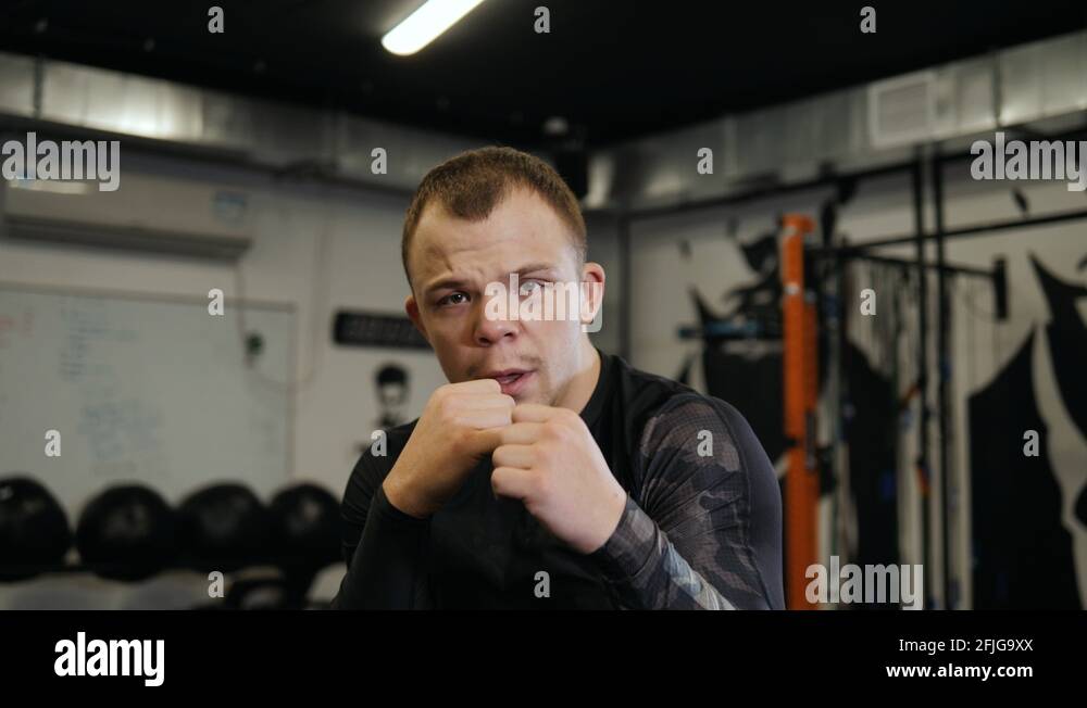 Boxer trains blows, without gloves. Boxing in the gym, fight with a