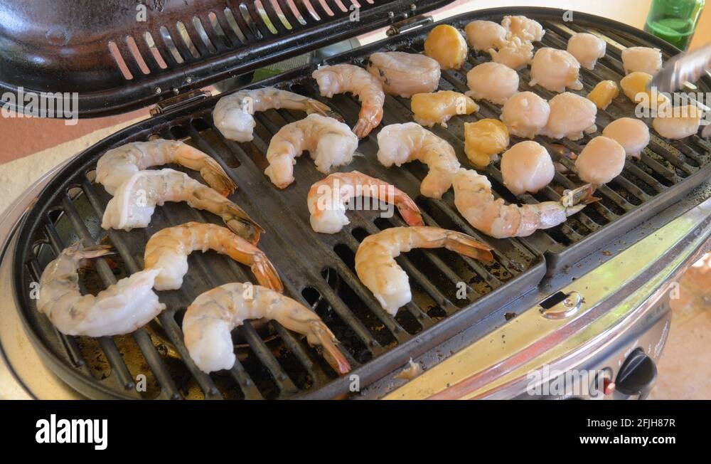 Cooking Shrimp and Scallops on a Cast Iron Grill in 4k Stock Video