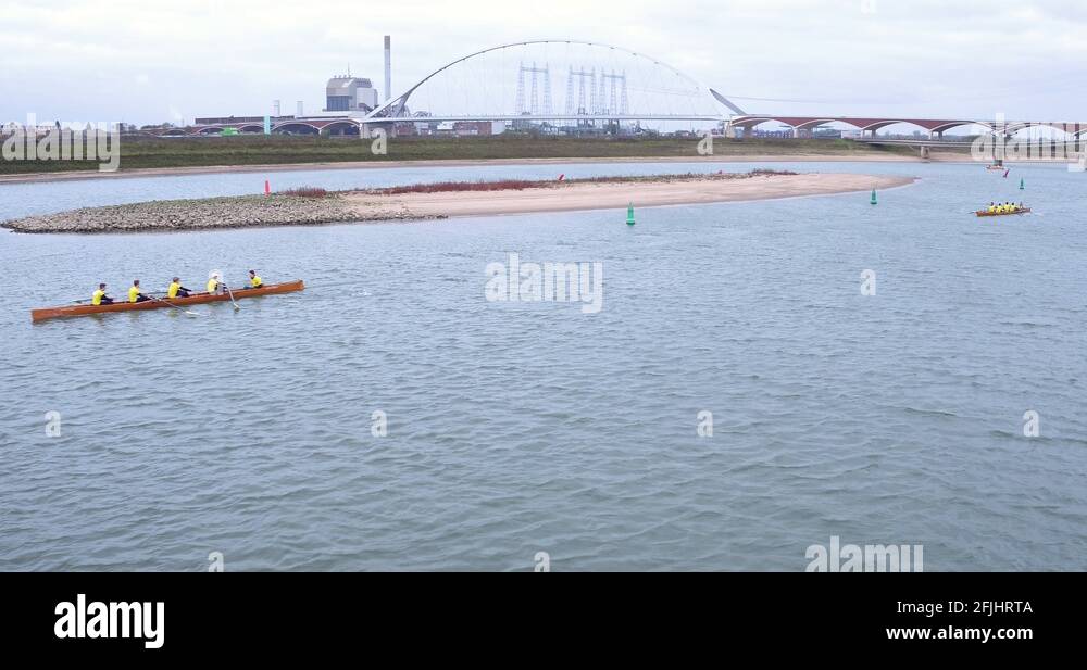 A close drone footage of a rowing competition in the Netherlands ...