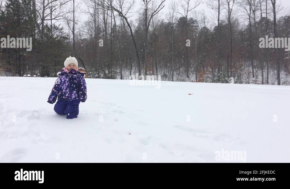 Walk In Deep Snow Little girl trying to walk in deep snow in yard at Christmas Stock ...