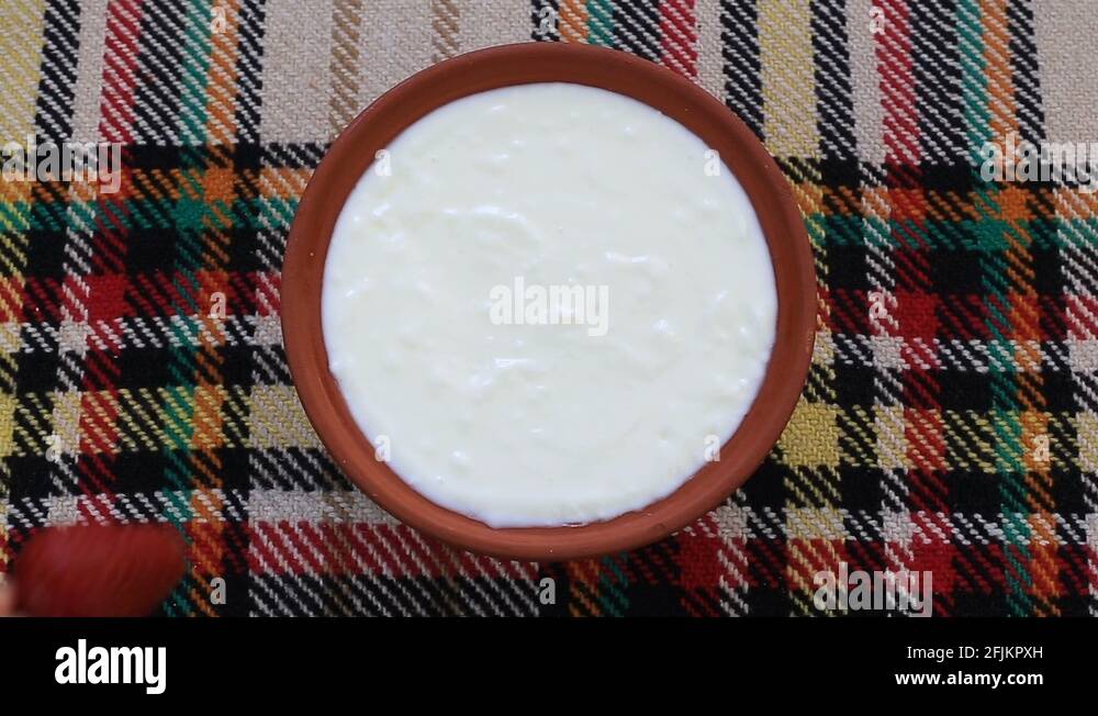 Dipping a strawberry in traditional bulgarian yogurt in a bowl Stock Video Footage Alamy