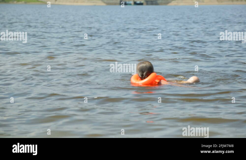 Girl in life jacket in water Stock Video Footage Alamy