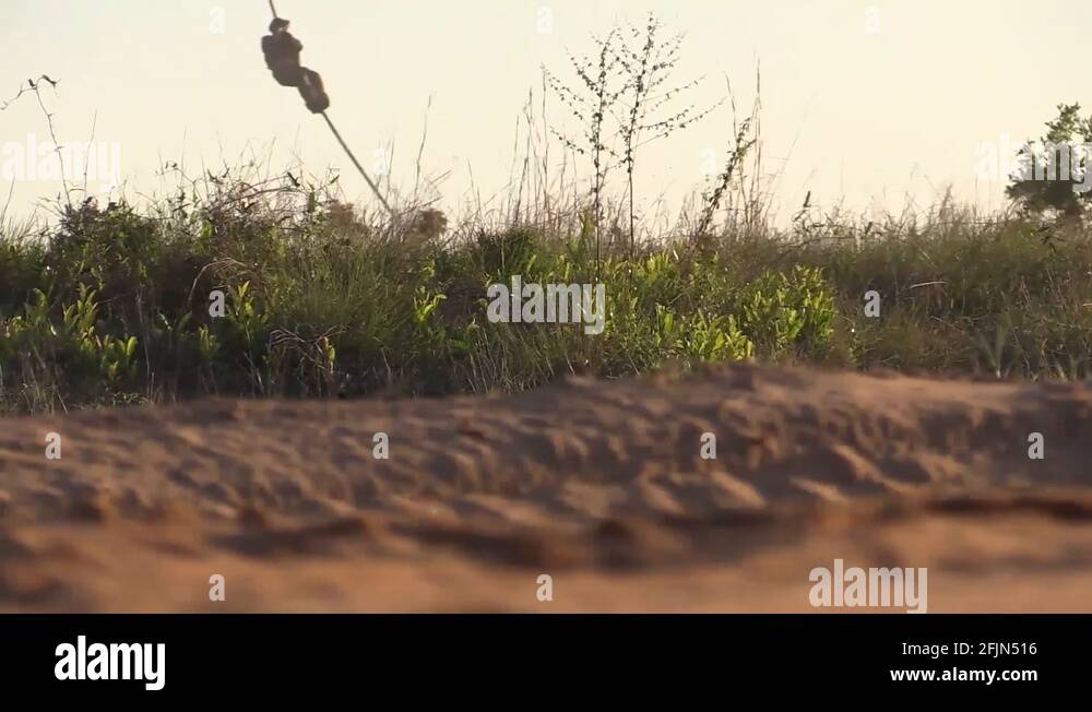 NATO special operations members conduct fast rope training out of a CV ...