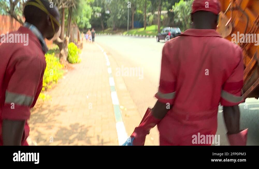 Workers putting bags of green waste inside a Garbage Truck Kigali