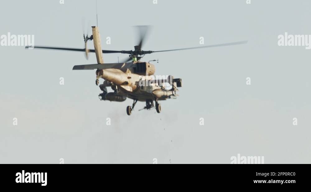 AH-64D Apache Longbow military helicopter attacking targets with canon ...