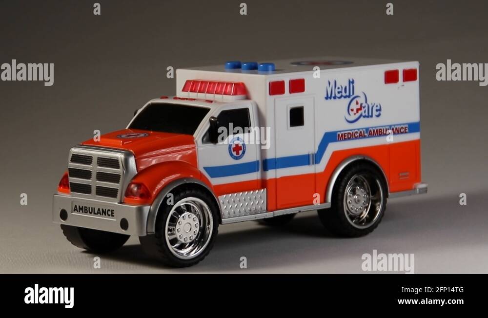 Dymanic zoom footage of toy ambulance with red flashing lights Stock