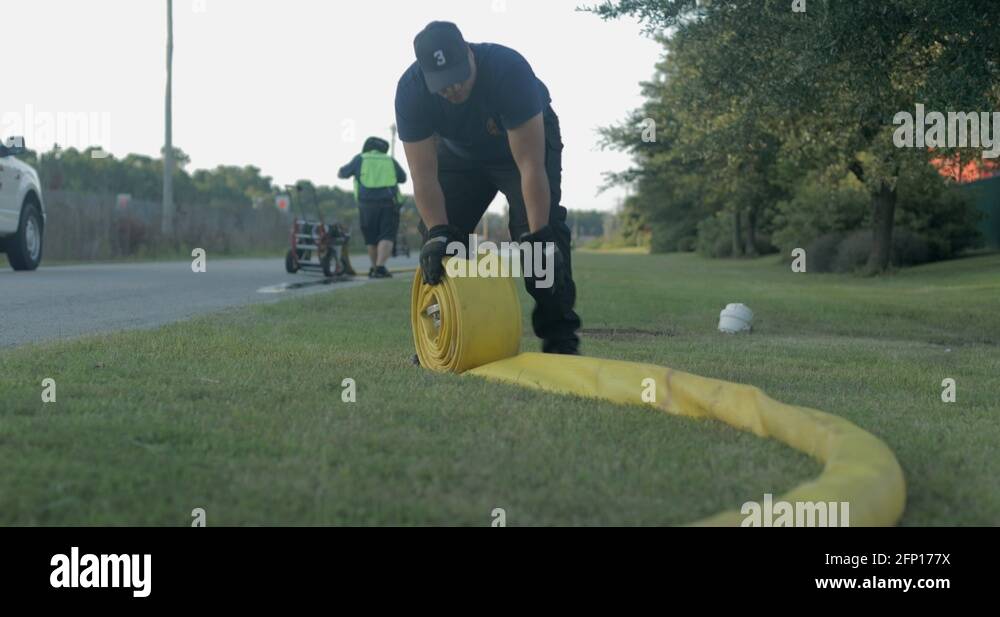 Firefighter rolls up fire hose Stock Videos & Footage HD and 4K Video