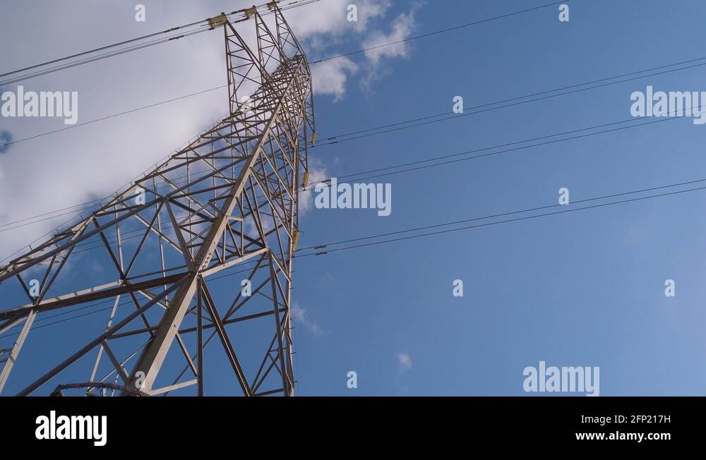 Electricity pylon in the middle of a farmers field with cables ...