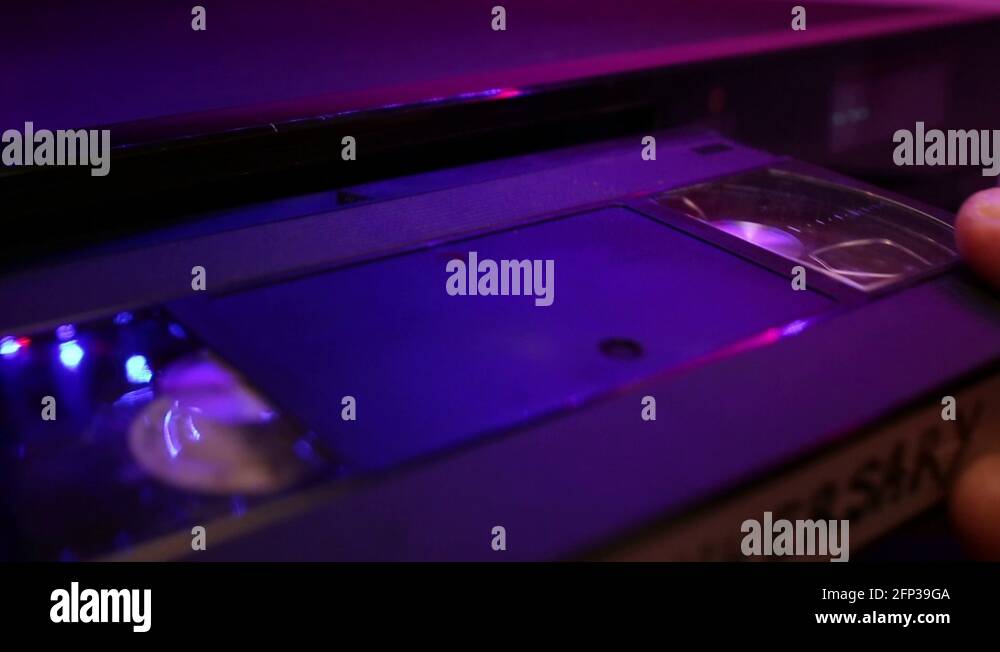 Inserting And Ejecting Anniversary VHS Video Tape. Close Up Of A VCR