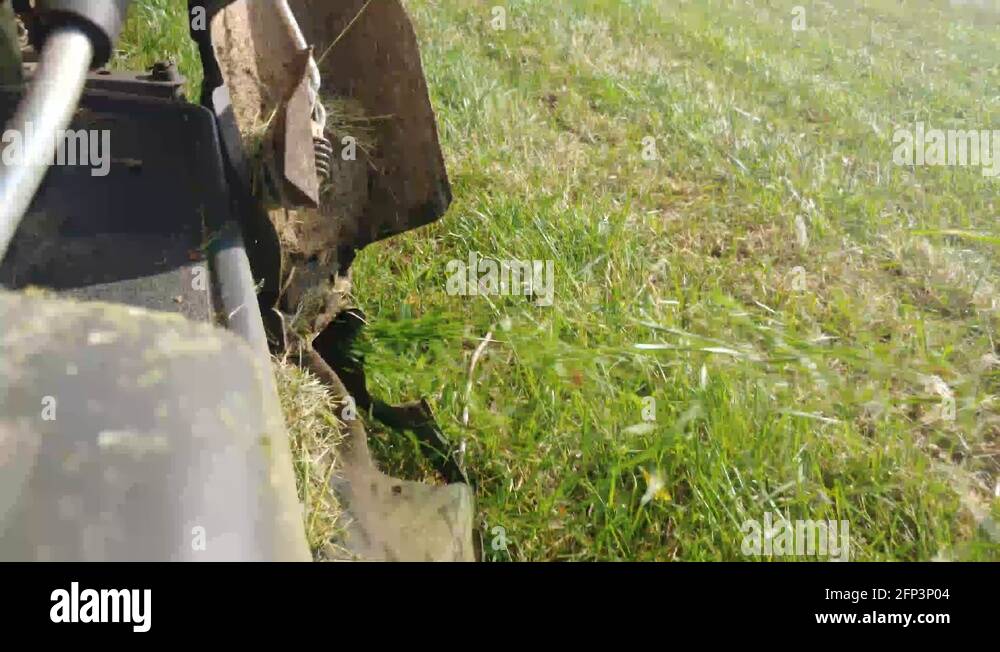 Action Shot of Tall Grass Being Spit Out of a Riding Lawn Mower Stock