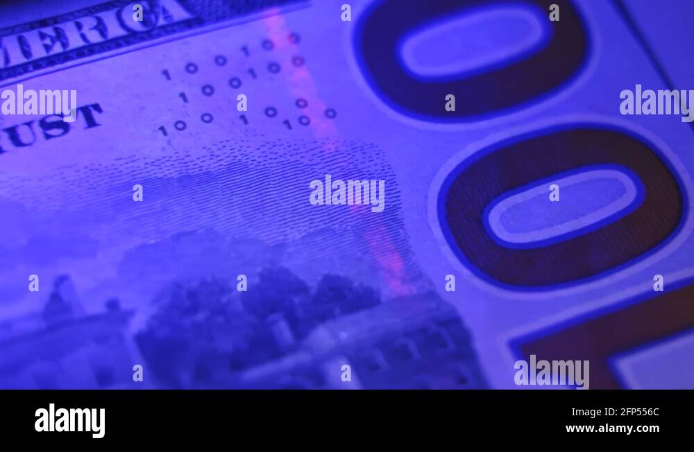 Close up of a one hundreddollar bill under blacklight, counterfeit UV