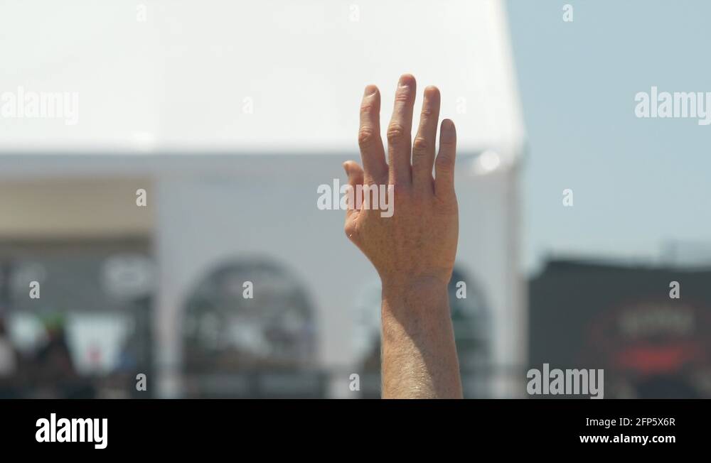 Women serve serving while playing pro beach volleyball in the sand