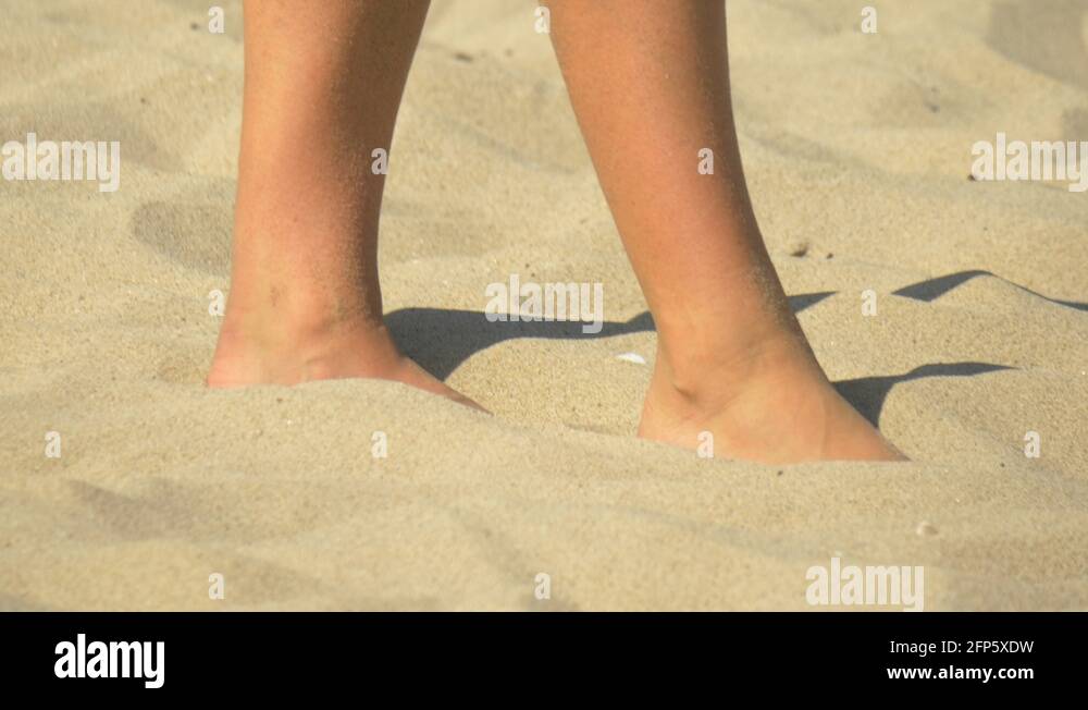 Women serve serving while playing pro beach volleyball in the sand