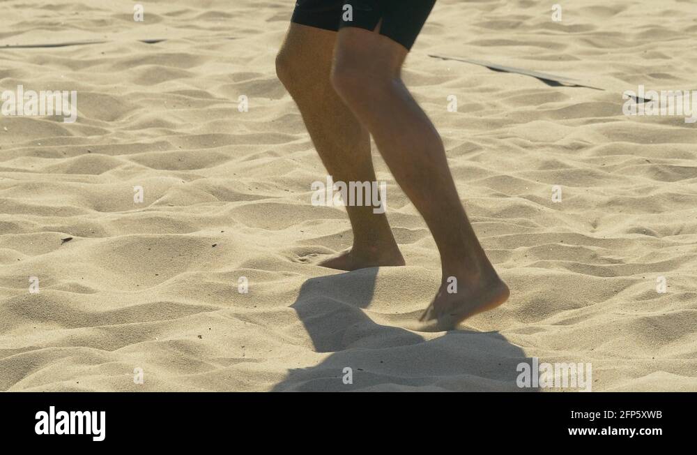A man diving and digging a ball in a beach volleyball game match in the