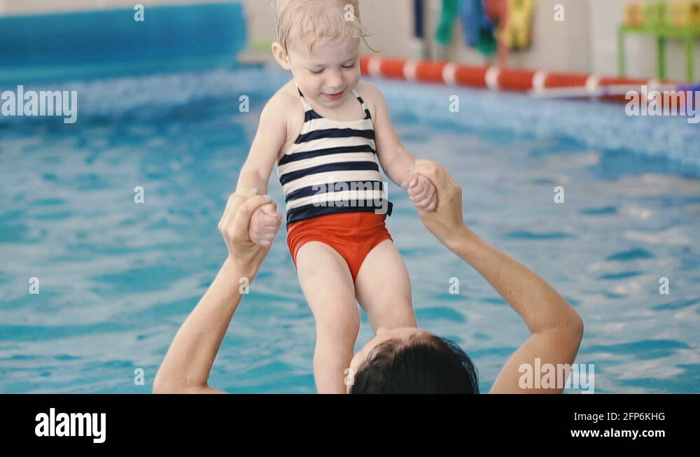 Swimming pool. Mom teaches a young child to swim in the pool Stock