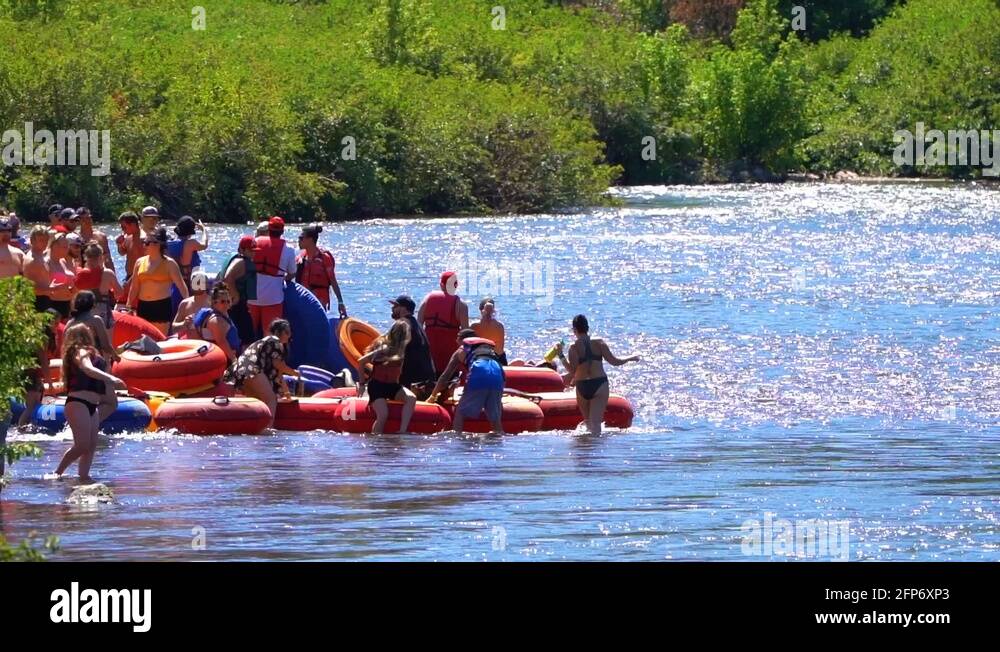 Tubers crowd the river entrance to float downstream on inflatable tubes