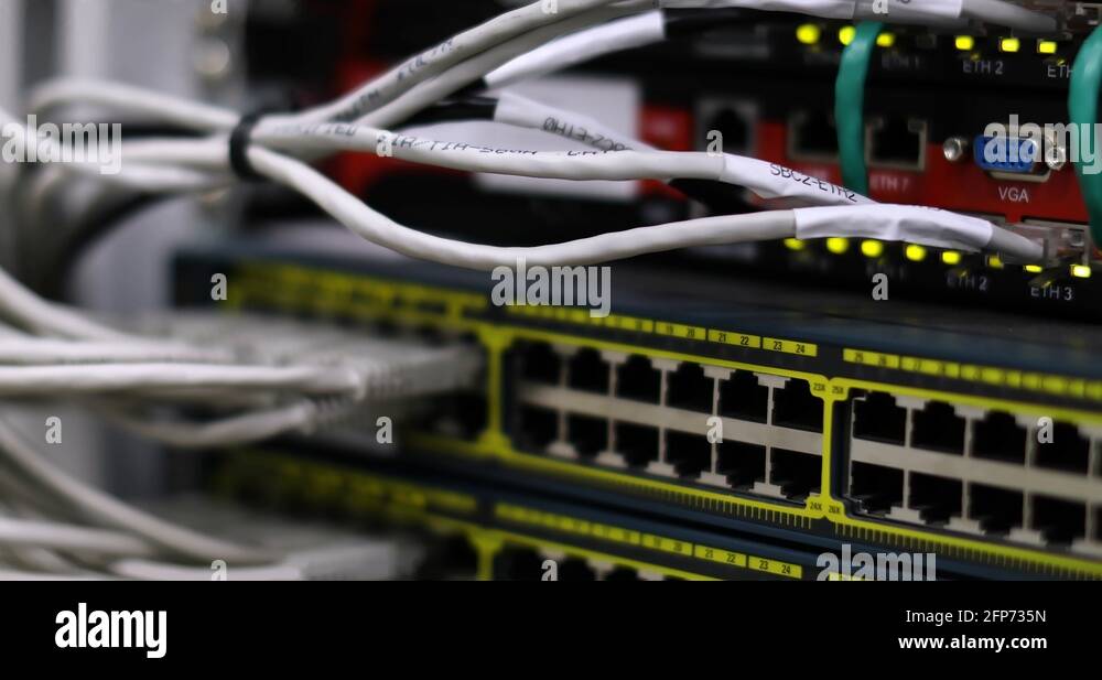 Switch And Optic Cable Connected To Network Panel With Blinking Leds