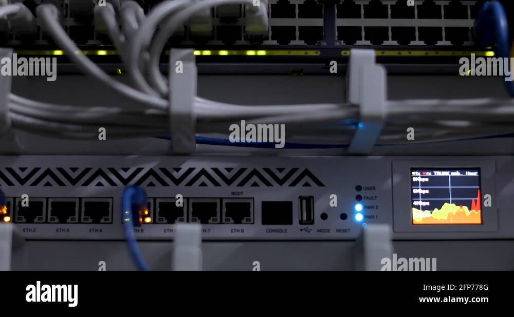 Switch And Optic Cable Connected To Network Panel With Blinking Leds